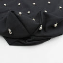 Black fabric with silver studs on a white background, Obroi