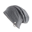A heather gray slouchy beanie hat featuring a silver metal O-ring detail on the side, shown against a plain white background, Obroi