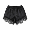 Black satin shorts with lace trim on a white background, Obroi