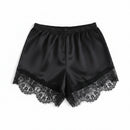 Black satin shorts with lace trim on a white background, Obroi