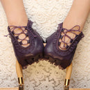 Purple lace-up shoes with gold accents on a textured white background, Obroi