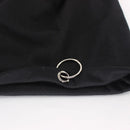 A silver-toned metal ring brooch with a double interlocking spiral design, displayed on a folded black fabric surface against a white background, Obroi