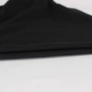 A close-up of folded black fabric with a fine ribbed texture on a plain white surface, Obroi