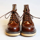 Pair of brown leather boots with laces on a light background, Obroi