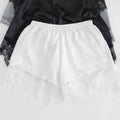 White lace pants with a black top on a white background, Obroi