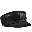 Black leather cap with decorative emblem on a white background, Obroi