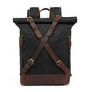 Black roll-top backpack with brown straps on a white background, Obroi