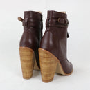 Brown leather ankle boots with wooden soles on a white background, branded 'Obroi'.