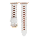 White watch strap with rose gold studs and rose gold buckle on a white background, Obroi
