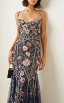 Woman wearing a floral dress with a neutral background, Obroi