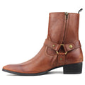 A brown leather ankle boot with a side zipper, a decorative strap across the instep with brass-tone rivets and buckle, and a low black block heel, shown from a side profile on a white background, Obroi