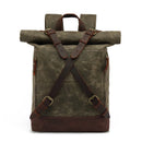 Green waxed canvas backpack with brown leather straps on a white background, Obroi
