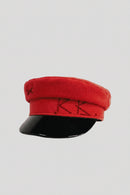 Red cap with black base on a light gray background, Obroi