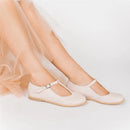 White flat shoes worn with a sheer skirt on a light background, Obroi