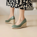 Green wedge shoes with jute sole worn by a person in a floral dress, Obroi