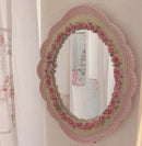Obroi Decorative mirror with floral frame on a white wall