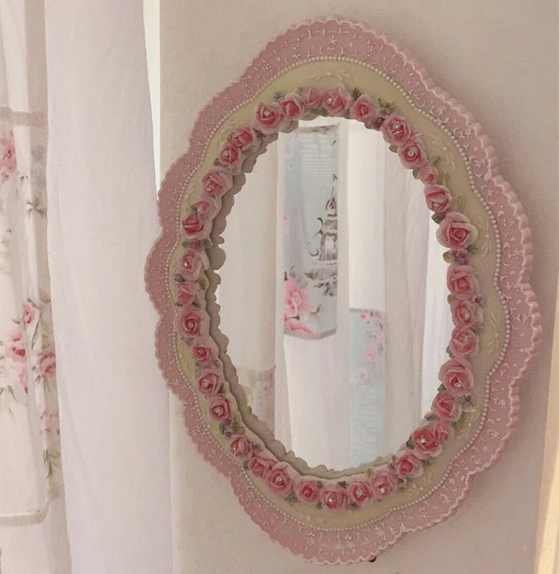 Obroi Decorative mirror with floral frame on a white wall