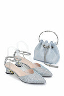 Silver glittery shoes and matching handbag on a white background, Obroi