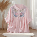 Pink dress with floral embroidery on a mannequin against a neutral background, Obroi