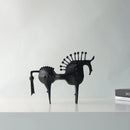Black horse sculpture on a white surface with a light gray background, Obroi