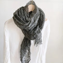 Gray scarf draped over a mannequin against a white background, Obroi