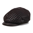 Black patterned cap with leather brim on a white background, Obroi