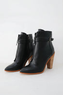 Black leather ankle boots with wooden heel on a white background, Obroi