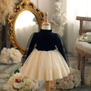 Mannequin wearing a black top and cream skirt in a decorative room with flowers and a mirror , Obroi