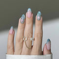 Hand with pastel nail polish and a ring on a neutral background, Obroi