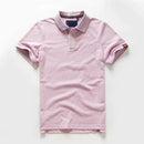 Pink polo shirt with brand label on a white background
