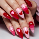 Nails with red and pink gradient design and heart shapes on a neutral background, Obroi