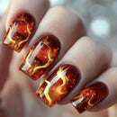 Nails with fiery design and gold accents on a blurred background, Obroi