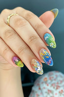 Close-up of a hand with colorful nail art on a blurred background, Obroi