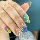 Hand with colorful floral nail art on a blurred background, Obroi