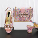 A women's fashion accessory set by Obroi   featuring a pink peep-toe slingback high-heel shoe, a matching pink handbag with gold chain straps, and a second shoe shown from the heel side, all decorated with iridescent mosaic patterns and crystal embellishments, Obroi