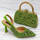 Green embellished shoes and matching handbag on a textured white surface, Obroi