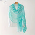 Turquoise scarf draped over a white shirt on a hanger against a white background, Obroi
