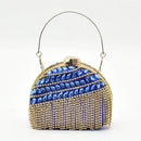Elegant handbag with blue gemstones and gold accents on a white background, Obroi