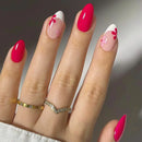 Obroi Hand with pink and white floral nail design on a neutral background