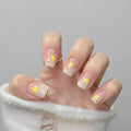 Hand with star-themed nail design on a neutral background