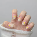 Hand with star-themed nail design on a neutral background