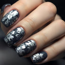 Nails with black and white floral design on a dark background, Obroi