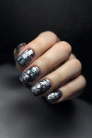 Nails with black and white floral design on a dark background, Obroi
