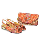 Decorative shoes and matching clutch with floral patterns on a white background, Obroi