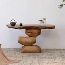 Wooden console table with rustic design against a white wall, Obroi