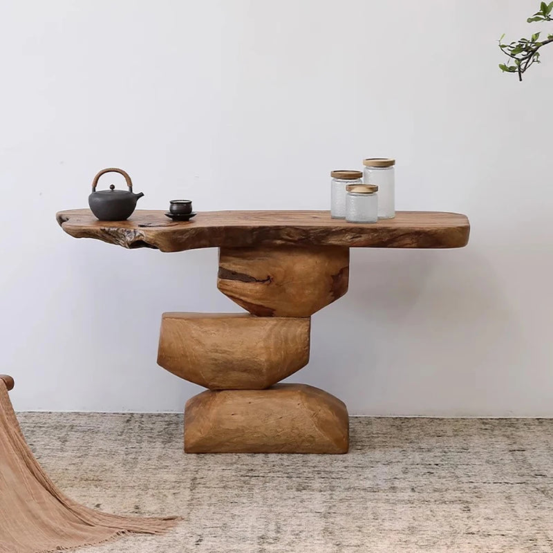 Wooden console table with rustic design against a white wall, Obroi