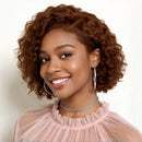 Woman with curly hair wearing a pink top and silver jewelry against a white background, Obroi
