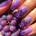 Nails with grape design and real grapes on a white background, Obroi