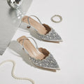 Silver embellished high heels on a light background, Obroi