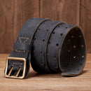 Black leather belt with gold buckle on a wooden surface, Obroi